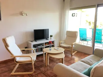 a living room with a couch and chairs and a tv at Apartamento La Mediterránea a 100 metros de la playa - Vilanova i la Geltrú - ES-332-1 in Vilanova i la Geltrú