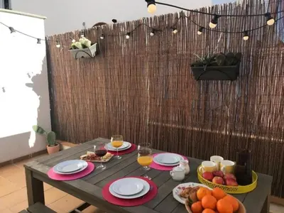 a table with food and a bowl of fruit on it at Casa familiar luminosa con piscina, cerca de la playa y parques, ideal para 6 personas en Cubelles - ES-332-5 in Cubelles