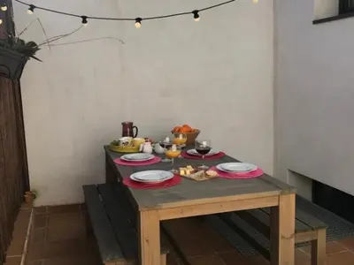 a table with plates of food on top of it at Casa familiar luminosa con piscina, cerca de la playa y parques, ideal para 6 personas en Cubelles - ES-332-5 in Cubelles