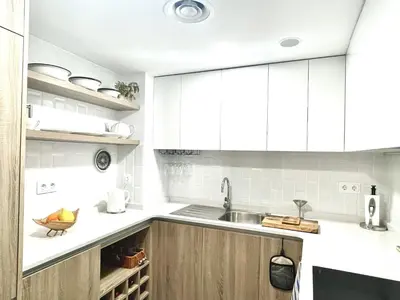 a kitchen with white cabinets and a sink at Apartamento Confortable con Parking Privado en el Centro de Vilanova i la Geltrú - ES-332-8 in Vilanova i la Geltrú