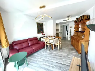 a living room with a red couch and a table at Apartamento Confortable con Parking Privado en el Centro de Vilanova i la Geltrú - ES-332-8 in Vilanova i la Geltrú