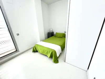 a bedroom with a bed and a mirror at Casa espaciosa con piscina, aire acondicionado y jardín cerca de la playa de Vilanova - ES-332-9 in Sant Pere de Ribes