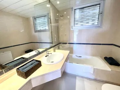 a bathroom with a sink and a bath tub at Casa espaciosa con piscina, aire acondicionado y jardín cerca de la playa de Vilanova - ES-332-9 in Sant Pere de Ribes