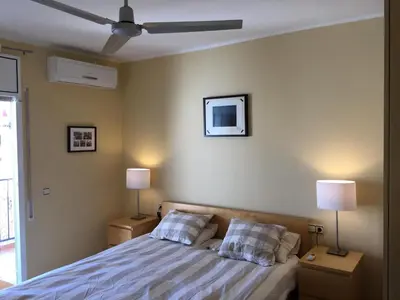 a bedroom with a bed with two pillows and two lamps at Ático Increíble con Terraza Privada en el Centro de Vilanova i la Geltrú - ES-332-7 in Vilanova i la Geltrú
