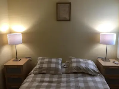 a bedroom with a bed with two lamps on it at Ático Increíble con Terraza Privada en el Centro de Vilanova i la Geltrú - ES-332-7 in Vilanova i la Geltrú