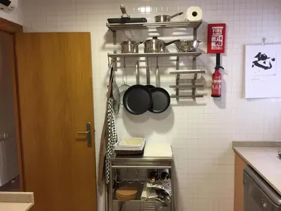 a kitchen with a counter with pots and pans on the wall at Ático Increíble con Terraza Privada en el Centro de Vilanova i la Geltrú - ES-332-7 in Vilanova i la Geltrú