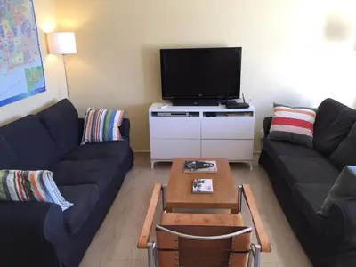 a living room with a couch and a tv at Ático Increíble con Terraza Privada en el Centro de Vilanova i la Geltrú - ES-332-7 in Vilanova i la Geltrú