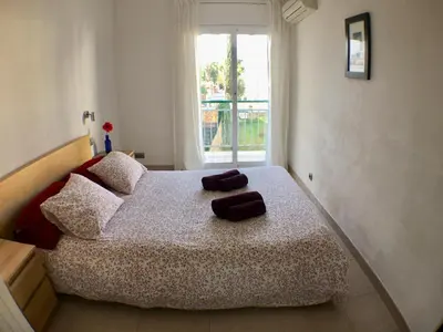 a bedroom with a bed with two towels on it at Apartamento Annie a 100 metros de la playa en Vilanova i la Geltrú, completamente equipado. - ES-332-3 in Vilanova i la Geltrú