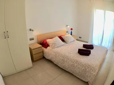 a bedroom with a large bed and a window at Apartamento Annie a 100 metros de la playa en Vilanova i la Geltrú, completamente equipado. - ES-332-3 in Vilanova i la Geltrú