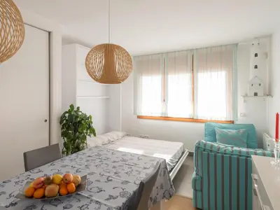 a room with a table with a bowl of fruit on it at Apartamento cómodo frente al mar con acceso directo a la playa - ES-332-6 in Vilanova i la Geltrú