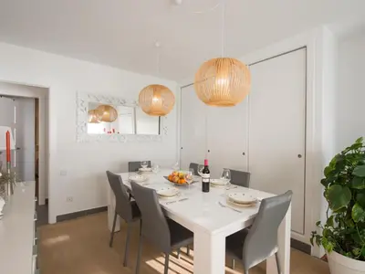 a white dining room with a white table and chairs at Apartamento cómodo frente al mar con acceso directo a la playa - ES-332-6 in Vilanova i la Geltrú