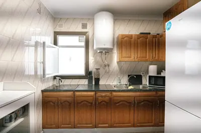 a kitchen with wooden cabinets and a sink at Cotonat in El Arrabal