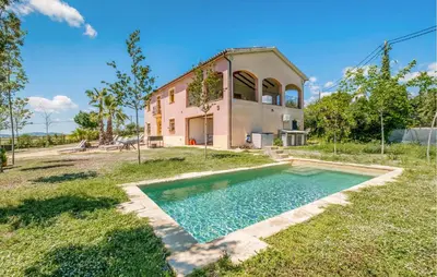 a house with a swimming pool in front of it at Beautiful Home In Guardiola De Fontrubí in La Guardiola
