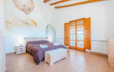 a bedroom with a bed and a wall with a fish mural at Beautiful Home In Guardiola De Fontrubí in La Guardiola