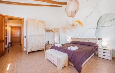 a bedroom with a bed and a painting on the wall at Beautiful Home In Guardiola De Fontrubí in La Guardiola