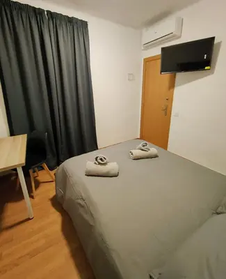 a bedroom with a bed with two towels on it at Apart Granollers Centre in Granollers