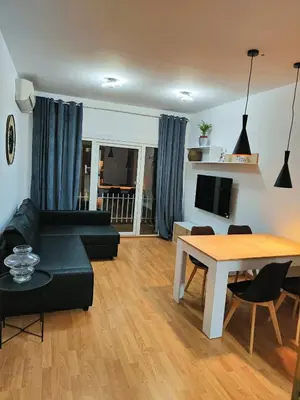 a living room with a black couch and a table at Apart Granollers Centre in Granollers