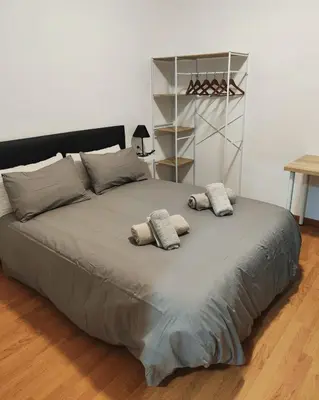 a large bed with two pillows on top of it at Apart Granollers Centre in Granollers