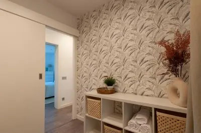 a hallway with a wall stenciled wallpaper at Opening Doors Poblenou Beach in Barcelona