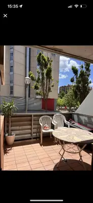 a patio with two chairs and a table on a balcony at Piso centro Sabadell 2 pax in Sabadell