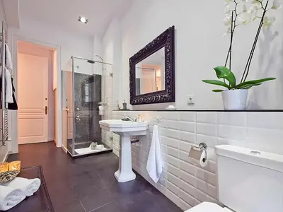 a white bathroom with a sink and a mirror at Flateli Universitat in Barcelona