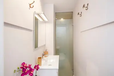 a bathroom with a sink and a mirror at Penthouse with private terrace in the center in Barcelona
