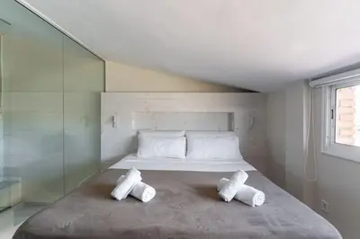 a bedroom with a bed with two pillows on it at Penthouse with private terrace in the center in Barcelona