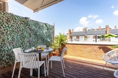 a patio with a table and chairs on a deck at Penthouse with private terrace in the center in Barcelona