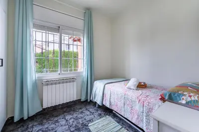 a bedroom with a bed and a window at Casa de vacances Mary in Santa Eulalia de Ronsaná