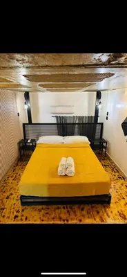 a bedroom with a yellow bed with two towels at Apart con terraza en Florida E2 in Hospitalet de Llobregat