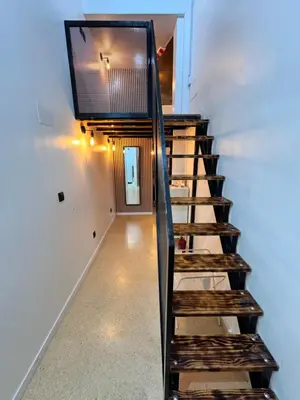 a staircase with a flat screen tv on the wall at Apart con terraza en Florida E2 in Hospitalet de Llobregat