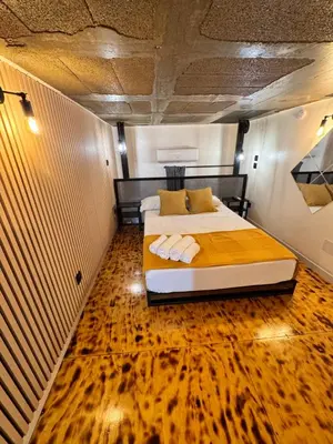 a bedroom with a bed and a wooden floor at Apart con terraza en Florida E2 in Hospitalet de Llobregat
