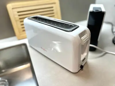 a white toaster sitting on top of a counter at Apartamento St Agustí - Centric in Mataró