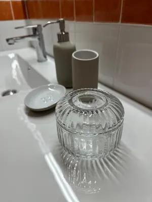 a glass bowl sitting on top of a sink at Apartamento St Agustí - Centric in Mataró