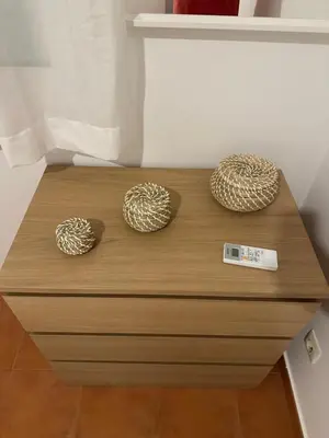 a wooden dresser with two spheres on top of it at Apartamento St Agustí - Centric in Mataró