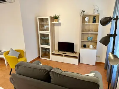 a living room with a couch and a television at Apartamento St Agustí - Centric in Mataró