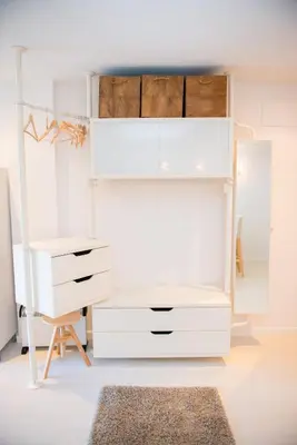 a white bedroom with a dresser and a desk at Opening Doors Pueblonuevo in Barcelona