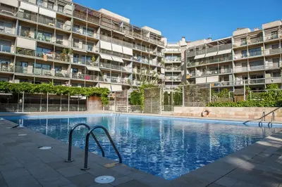 a swimming pool in front of a large apartment building at Opening Doors Pueblonuevo in Barcelona