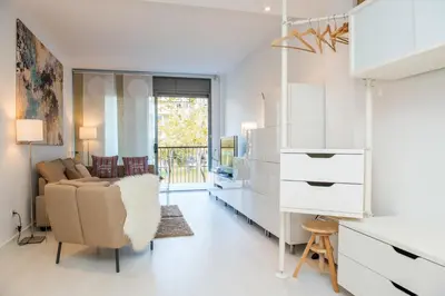 a white living room with a couch and a table at Opening Doors Pueblonuevo in Barcelona