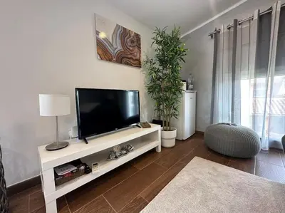 a living room with a flat screen tv on a white entertainment center at Casa Salud in Piera