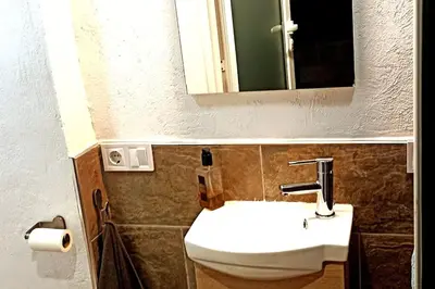 a bathroom with a white sink and a mirror at Casa Salud in Piera