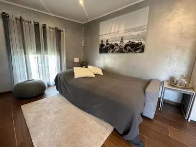 a bedroom with a large bed and a large window at Casa Salud in Piera
