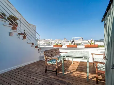 a patio with a table and chairs on a balcony at Panoramic Terraces by Hello Homes Sitges in Sitges