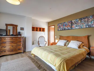 a bedroom with a large bed and a dresser at Panoramic Terraces by Hello Homes Sitges in Sitges
