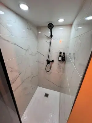 a bathroom with a shower with a glass door at Precioso estudio con terraza en Florida E1 in Hospitalet de Llobregat