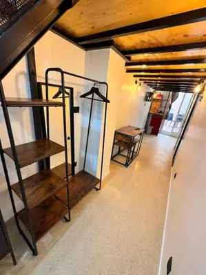 a room with stairs and a table in a building at Precioso estudio con terraza en Florida E1 in Hospitalet de Llobregat
