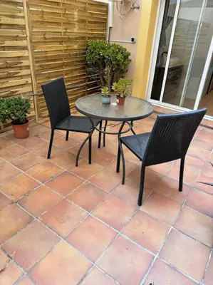 two chairs and a table on a patio at Precioso estudio con terraza en Florida E1 in Hospitalet de Llobregat
