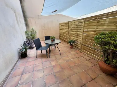 a patio with a table and chairs and plants at Precioso estudio con terraza en Florida E1 in Hospitalet de Llobregat