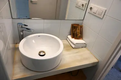 a bathroom with a white sink and a mirror at Homenfun Barcelona Hospital Clínic l in Barcelona