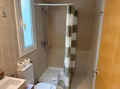 a bathroom with a shower and a toilet and a sink at Homenfun Barcelona Hospital Clínic l in Barcelona